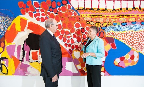 Deborah Cheetham with Darvell M Hutchinson standing in front of Indigenous artwork, Dulka Warngiid (Land of All) 2007